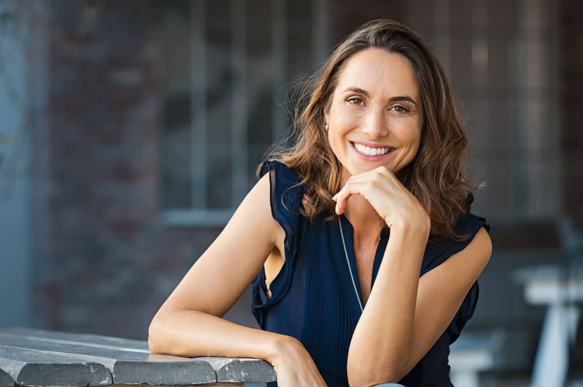 A woman smiles warmly, reflecting on her health journey.
